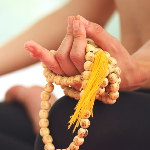Meditierende Frau mit Mala oder Gebetskette